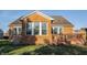 Backyard view of a brick home featuring a deck and well-maintained lawn at 405 Letterman Dr, Brownsburg, IN 46112