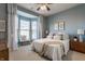 Cozy bedroom featuring a bay window, ceiling fan, and neutral decor at 405 Letterman Dr, Brownsburg, IN 46112