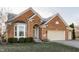 Beautiful brick home with a two-car garage, a manicured lawn, and a bay window at 405 Letterman Dr, Brownsburg, IN 46112
