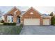 Charming brick home featuring a two-car garage, landscaped front yard, and inviting entrance at 405 Letterman Dr, Brownsburg, IN 46112