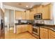 Bright kitchen featuring stainless steel appliances, granite countertops, and light wood cabinets at 405 Letterman Dr, Brownsburg, IN 46112