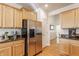 Well-lit kitchen with stainless steel refrigerator and light wood cabinetry at 405 Letterman Dr, Brownsburg, IN 46112