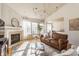 Spacious living room with hardwood floors, a fireplace, and large windows for ample sunlight at 405 Letterman Dr, Brownsburg, IN 46112