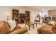 Inviting living room featuring hardwood bookcases, plush seating, area rugs, and a neutral color palette at 405 Letterman Dr, Brownsburg, IN 46112