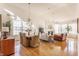 Bright living and dining area with hardwood floors, large windows, and a cozy fireplace at 405 Letterman Dr, Brownsburg, IN 46112