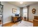 Bright home office featuring a wooden desk, a window, and hardwood floors at 405 Letterman Dr, Brownsburg, IN 46112