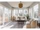 Sunroom filled with natural light, neutral furnishings and access to the outdoor deck at 405 Letterman Dr, Brownsburg, IN 46112