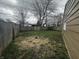 View of the backyard with a wooden fence and budding foliage on the trees at 447 S Bradley Ave, Indianapolis, IN 46201