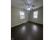 This is a bedroom with brown floors, a ceiling fan, and two windows with white trim at 447 S Bradley Ave, Indianapolis, IN 46201