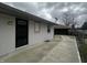 View of home exterior showing brick and detached garage with paved driveway at 447 S Bradley Ave, Indianapolis, IN 46201