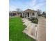 Inviting single-story home with well-kept lawn, patterned walkway, and lush landscaping at 447 S Bradley Ave, Indianapolis, IN 46201