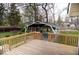 A wooden deck overlooking a backyard with a covered carport and grassy areas, great for outdoor living at 4504 Winthrop Ave, Indianapolis, IN 46205