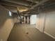 Spacious basement area with painted floor, exposed ductwork, and painted concrete walls at 4504 Winthrop Ave, Indianapolis, IN 46205