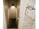 Basement stairs leading to a kitchen with bright white cabinets and modern black hardware and sleek countertops at 4504 Winthrop Ave, Indianapolis, IN 46205
