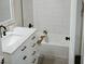 Bright bathroom featuring white marble tile, a soaking tub, and black hardware at 4504 Winthrop Ave, Indianapolis, IN 46205