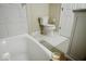 Bright bathroom featuring white tile, toilet, and marble flooring at 4504 Winthrop Ave, Indianapolis, IN 46205