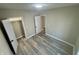 Neutral bedroom featuring wood-look flooring, fresh paint, and a closet with ample storage space at 4504 Winthrop Ave, Indianapolis, IN 46205