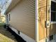 Side exterior view of home showing the vinyl siding and surrounding lawn and landscaping at 4504 Winthrop Ave, Indianapolis, IN 46205