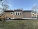 Exterior view of home with low landscaping and stairs to a rear entrance at 4504 Winthrop Ave, Indianapolis, IN 46205