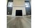 Living room fireplace featuring a white brick surround and modern gray flooring and paint at 4504 Winthrop Ave, Indianapolis, IN 46205