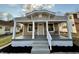 Charming bungalow featuring a covered front porch, freshly painted with new landscaping at 4504 Winthrop Ave, Indianapolis, IN 46205