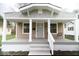 Charming home featuring a covered front porch with white columns and updated exterior at 4504 Winthrop Ave, Indianapolis, IN 46205