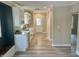 Modern eat-in kitchen featuring white cabinets, quartz countertops, and hardwood floors at 4504 Winthrop Ave, Indianapolis, IN 46205