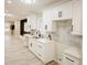 Well-lit kitchen featuring white cabinetry, stainless steel appliances, and a stylish backsplash at 4504 Winthrop Ave, Indianapolis, IN 46205