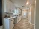 Bright kitchen with white cabinets, stainless steel sink, wood-look flooring and natural light window at 4504 Winthrop Ave, Indianapolis, IN 46205