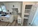Kitchen featuring white cabinets, marble backsplash, pantry, and modern black hardware at 4504 Winthrop Ave, Indianapolis, IN 46205