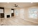 Bright living room featuring a fireplace, new flooring, and lots of natural light at 4504 Winthrop Ave, Indianapolis, IN 46205