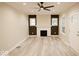 Spacious living room with a fireplace, ceiling fan, and ample natural light at 4504 Winthrop Ave, Indianapolis, IN 46205