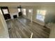 Open-concept living area with refinished fireplace, new flooring, and plenty of natural light at 4504 Winthrop Ave, Indianapolis, IN 46205