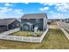 Aerial view of the backyard, showcasing the playhouse and white picket fence at 491 Tracewood Bnd, Greenfield, IN 46140