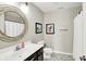 Stylish bathroom featuring a modern vanity, decorative mirror, and patterned flooring at 491 Tracewood Bnd, Greenfield, IN 46140