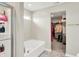 This bathroom features a large white bathtub, shower with glass door and a walk in closet at 491 Tracewood Bnd, Greenfield, IN 46140