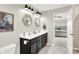 This bathroom has double sinks, hexagon floors, modern lighting and a framed painting of a cat at 491 Tracewood Bnd, Greenfield, IN 46140