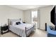 This cozy bedroom features a black metal frame bed, bedside tables, and a bright window at 491 Tracewood Bnd, Greenfield, IN 46140