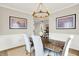 Elegant dining room featuring a decorative chandelier, stylish table setting, and bright, neutral tones at 491 Tracewood Bnd, Greenfield, IN 46140