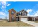 Charming two-story home boasts brick and siding details, a two-car garage, and a neatly landscaped yard at 491 Tracewood Bnd, Greenfield, IN 46140
