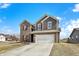 Beautiful two-story home featuring brick and siding, a two-car garage, and a well-manicured lawn on a bright, sunny day at 491 Tracewood Bnd, Greenfield, IN 46140