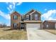 Attractive two-story home with a brick and siding facade, a two-car garage, and an inviting front yard at 491 Tracewood Bnd, Greenfield, IN 46140