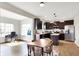Kitchen features dark cabinets, stainless appliances, island, adjacent dining area, and an office at 491 Tracewood Bnd, Greenfield, IN 46140