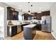 Modern kitchen with dark cabinets, stainless steel appliances, and center island for food prep and entertaining at 491 Tracewood Bnd, Greenfield, IN 46140