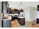Modern kitchen with dark cabinets, stainless steel appliances, and center island for food prep and entertaining at 491 Tracewood Bnd, Greenfield, IN 46140