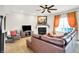 Cozy living room with a plush leather sofa, fireplace, and a TV, perfect for relaxation at 491 Tracewood Bnd, Greenfield, IN 46140