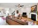 Open living room features hardwood floors, fireplace, and ceiling fan, creating a cozy gathering space at 491 Tracewood Bnd, Greenfield, IN 46140
