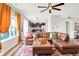 Open-concept living room with hardwood floors, ample seating, and a view into the kitchen at 491 Tracewood Bnd, Greenfield, IN 46140