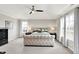 This main bedroom features a large bed, carpeted floors, multiple windows, and a ceiling fan at 491 Tracewood Bnd, Greenfield, IN 46140