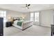 This main bedroom features a large bed, carpeted floors, multiple windows, and a ceiling fan at 491 Tracewood Bnd, Greenfield, IN 46140